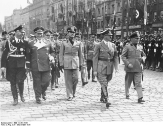 Hitler Archive | Adolf Hitler is standing in his open car while driving ...